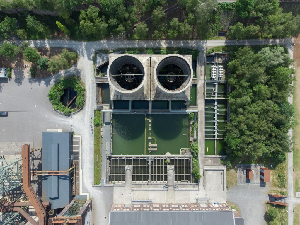 pexels-photo-12634302-12634302 Aerial view of industrial water treatment facility surrounded by greenery in Bochum, Germany.